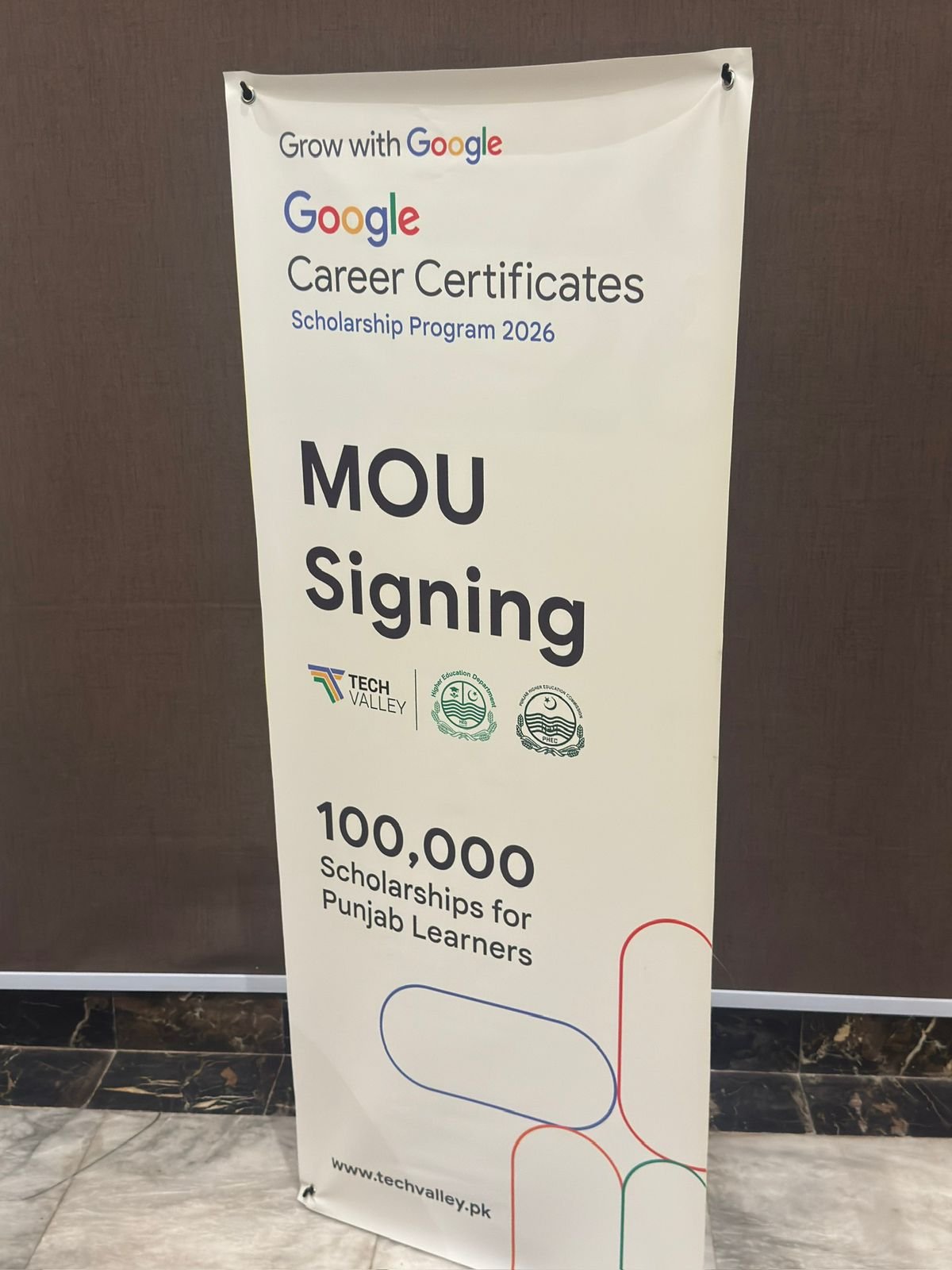 MoU signing banner for 100,000 scholarships for Punjab learners